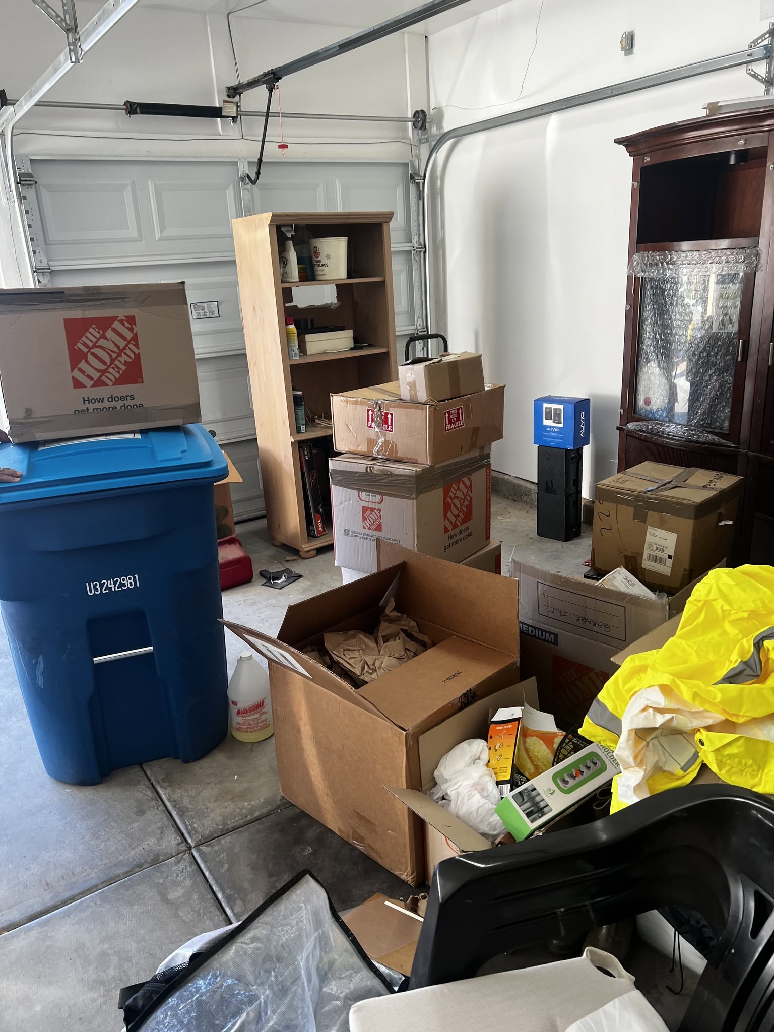 A garage full of boxes and stored items being cleared out by LWP Hauling